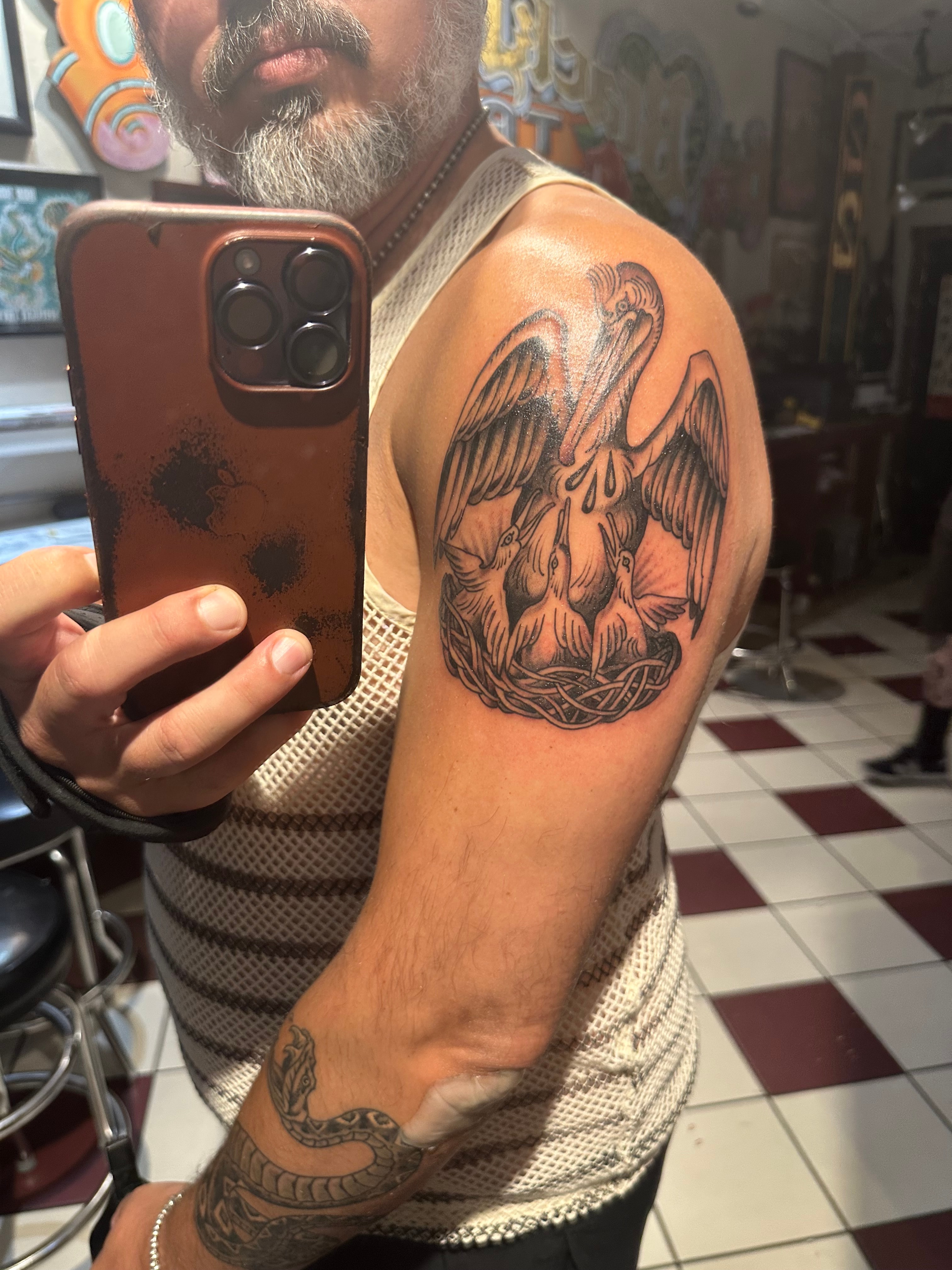 Pelican with 3 Baby Chicks Tattoo by Moses Saarni